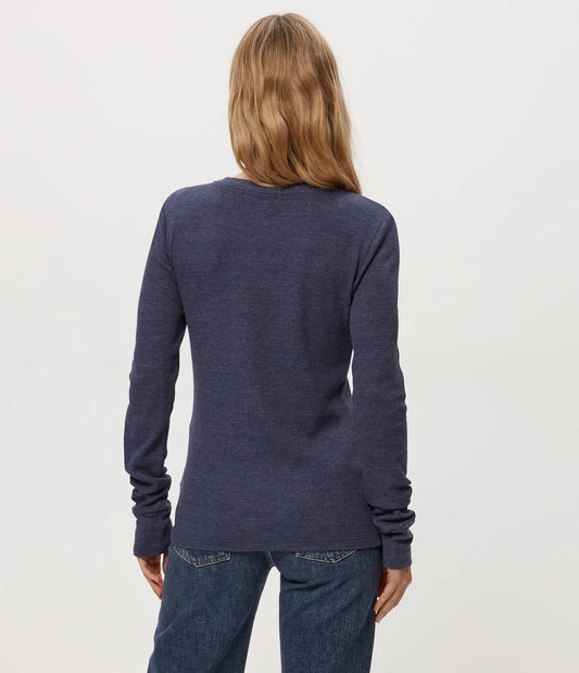long sleeve thermal crewneck layering top wearing a navy long-sleeve shirt and jeans on a light gray background