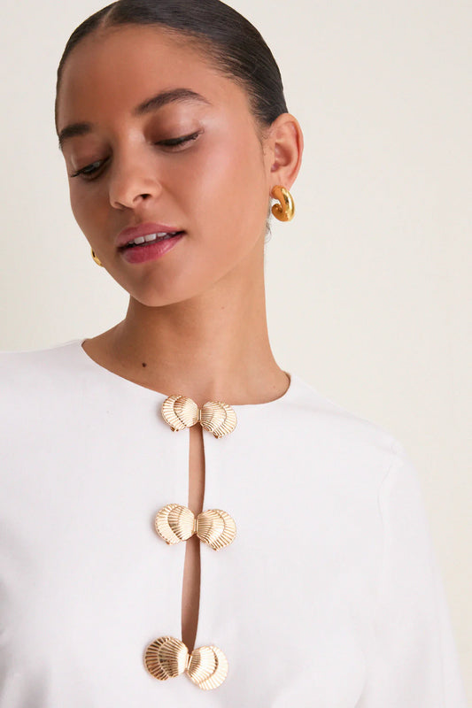 Ivory linen mini caftan — close-up of gold shell hardware detail and keyhole cut-out neckline