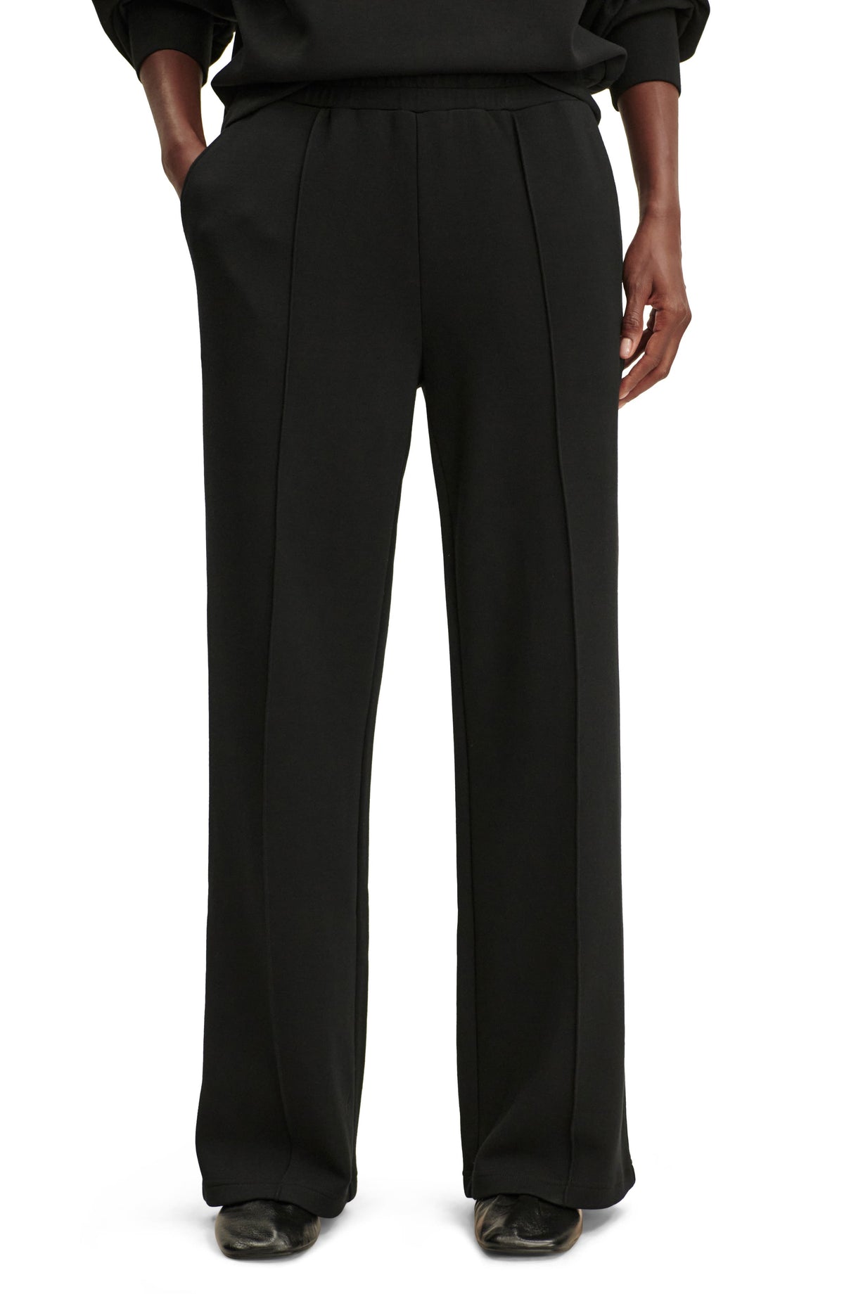 Black wide leg knit pants with raised front seams and elastic waist, front view on model