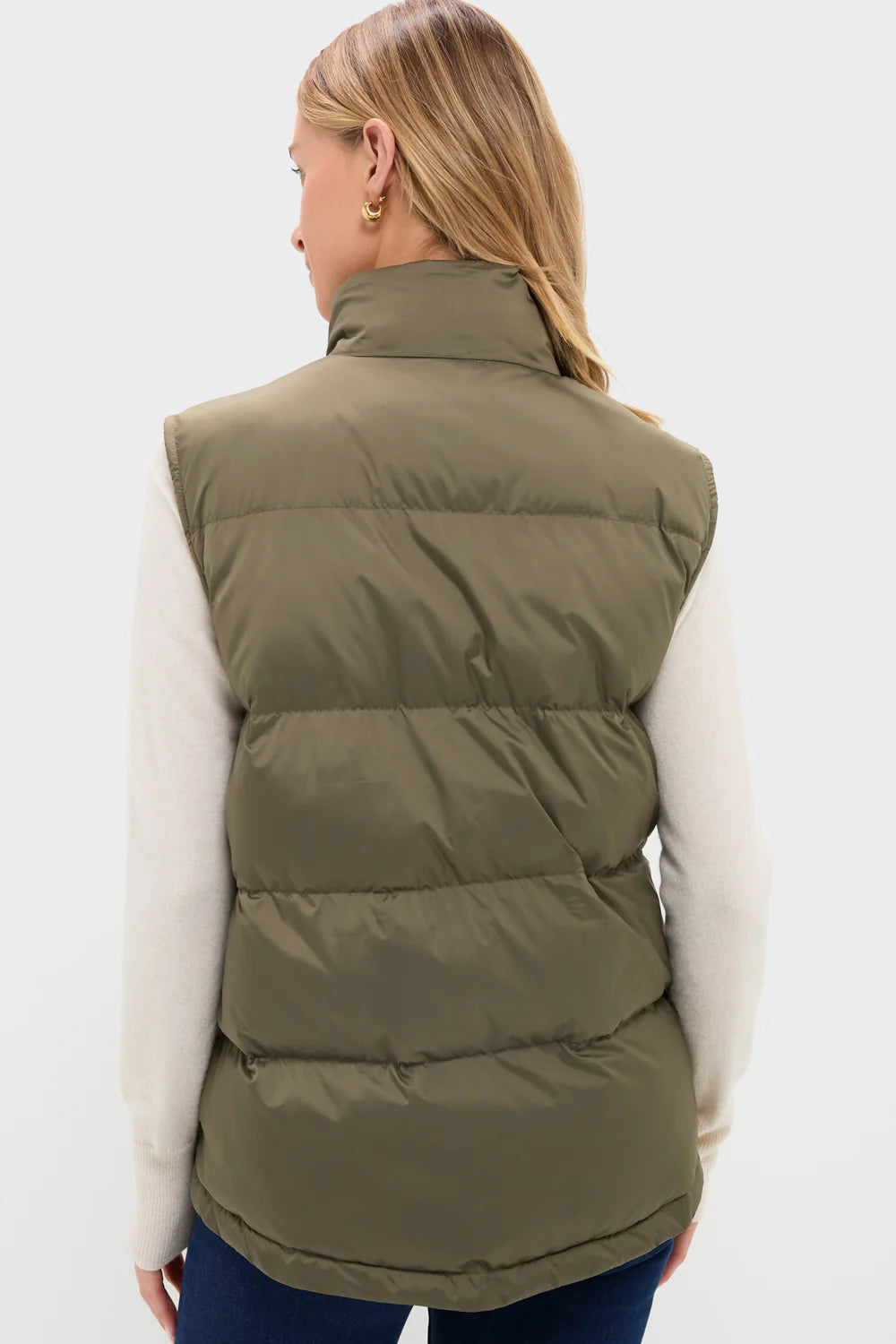 Back view-Person wearing an olive green puffer vest on a white background
