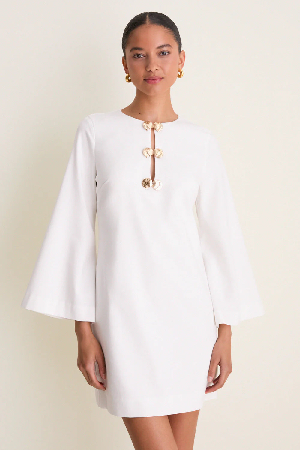 Ivory linen mini caftan — close-up of gold shell hardware detail and keyhole cut-out neckline