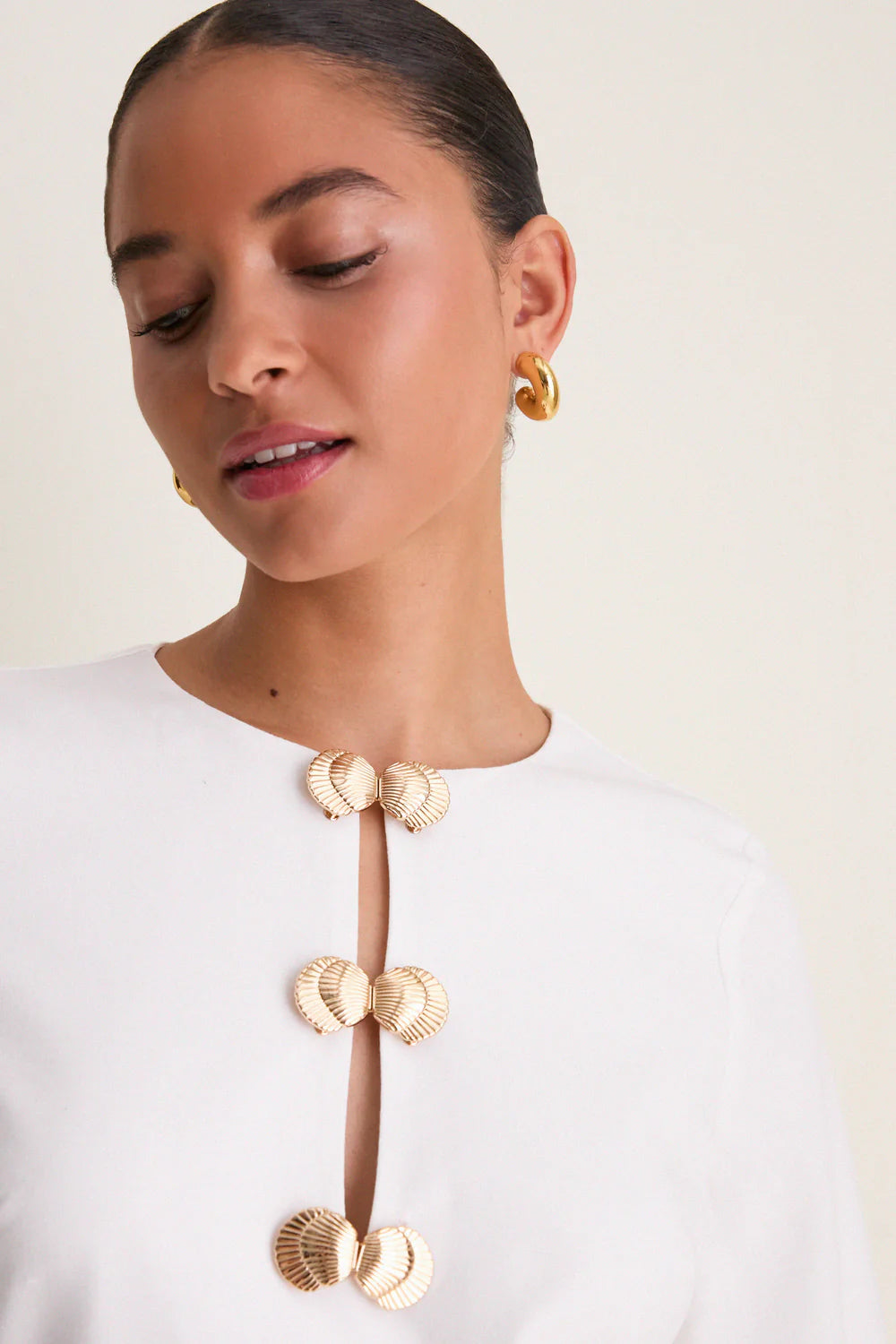 Ivory linen mini caftan — close-up of gold shell hardware detail and keyhole cut-out neckline