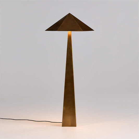 Modern brass geometric floor lamp with a geometric design on a light gray background