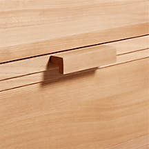 Close up on light wood console of wooden drawer pull  handle 