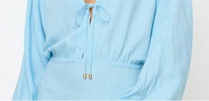 light blue mini coverup dress — close up of lightweight material and relaxed fit, detail shot