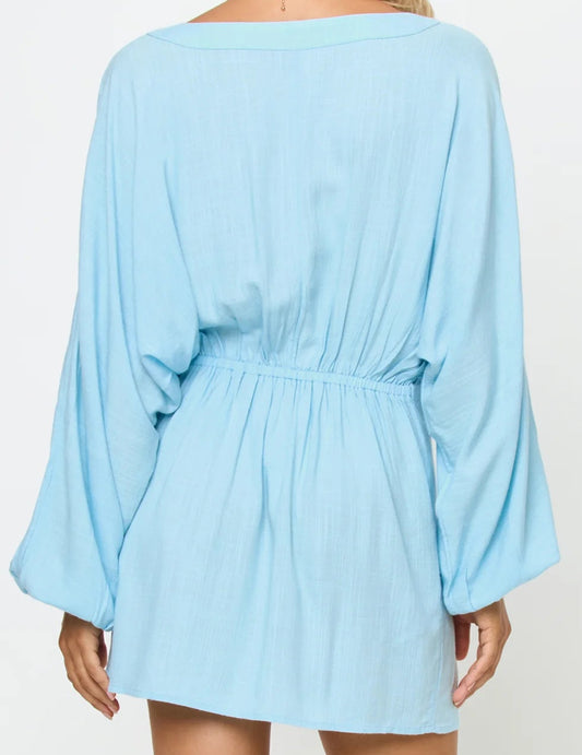 light blue mini coverup dress rear view worn by a person on a white background, 