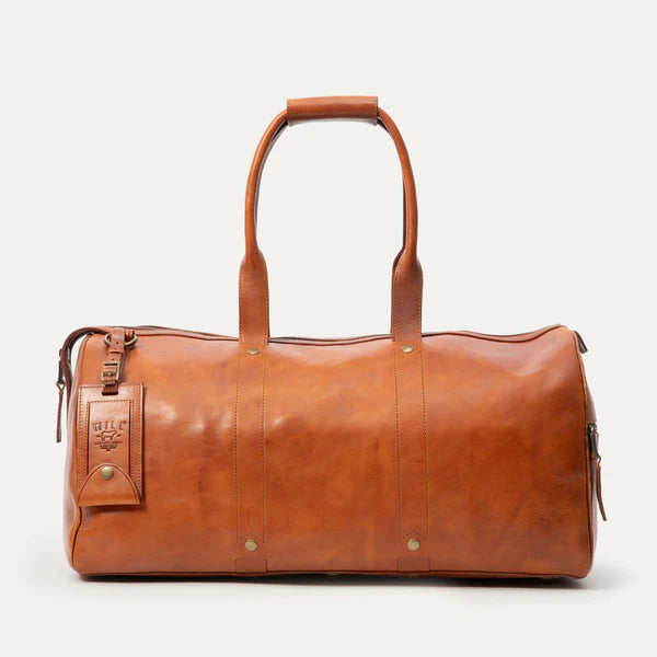 Leather travel duffle bag in Cognac shown in side view