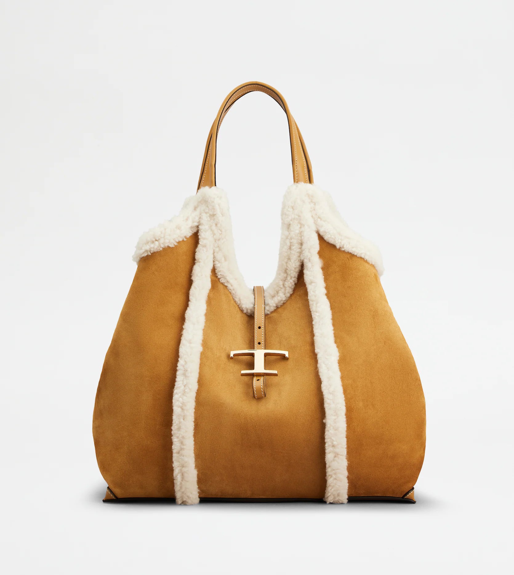 Medium suede shopping bag with soft sheepskin-Front view white backdrop- piping and metal T pendant Full front view with sides tucked in against white backdrop