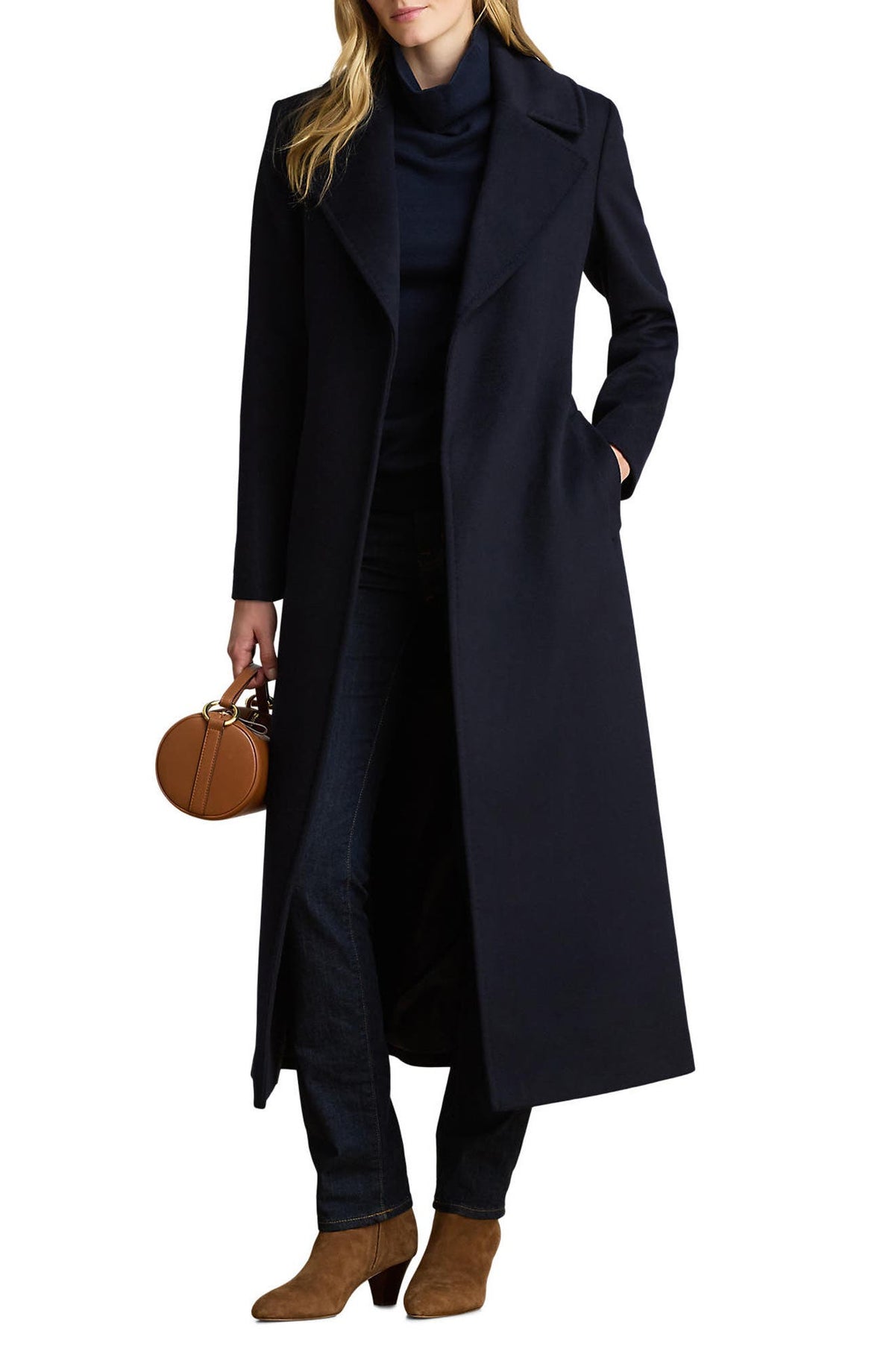 Long navy wrap coat with notched lapels worn open over a navy turtleneck and jeans, front view on model