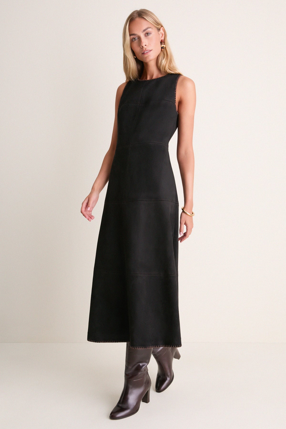 Black vegan suede midi dress with brown whipstitch trim, worn with brown knee-high boots