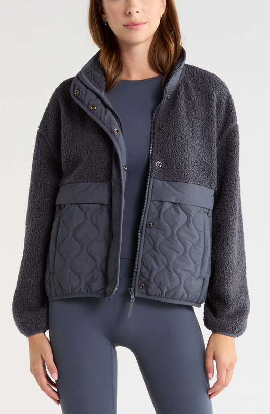 Navy mixed media jacket with plush body and quilted lower panels, front view on model