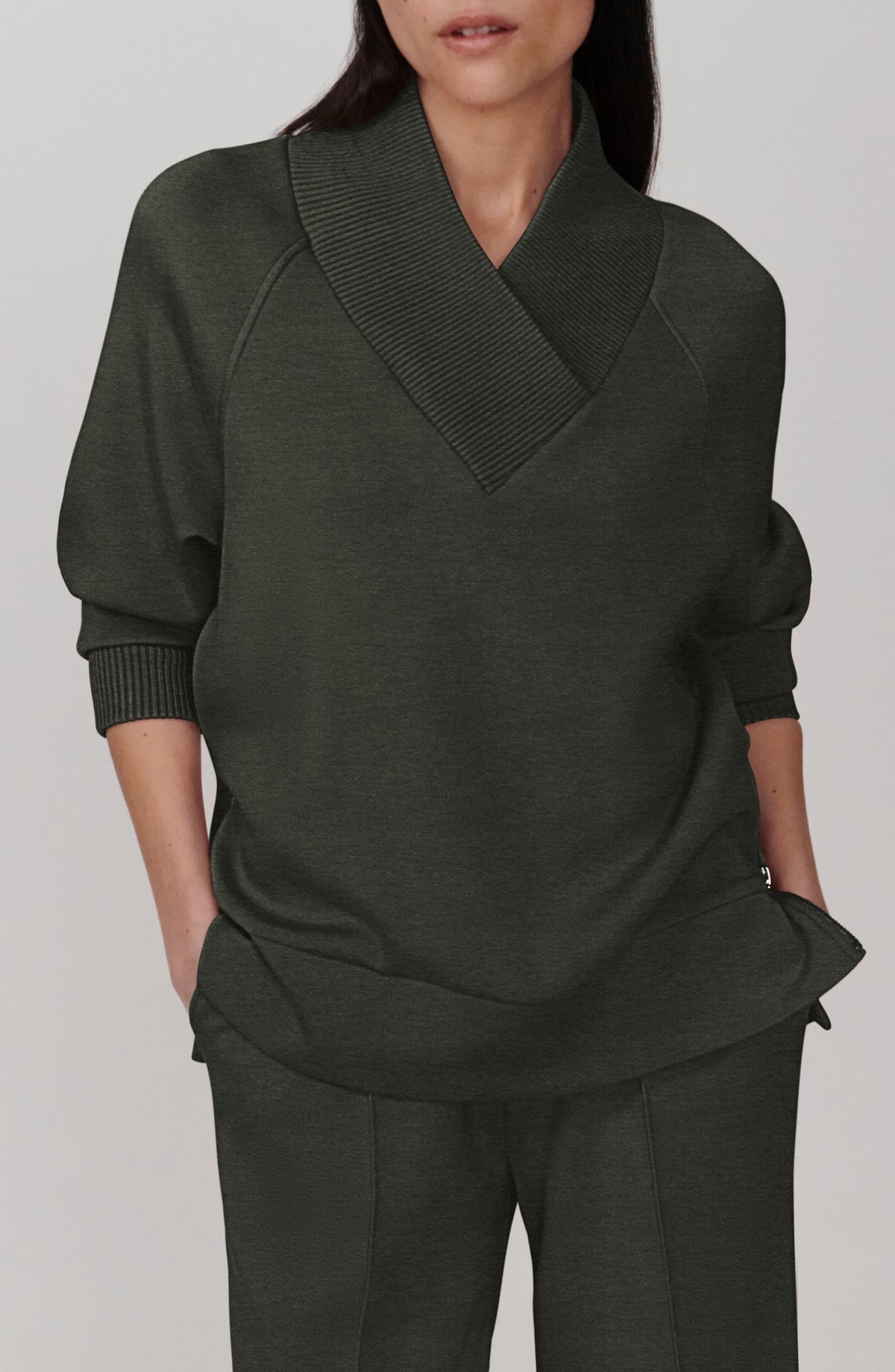 Olive shawl collar pullover with ribbed V-neck collar and ribbed cuffs, front view on model