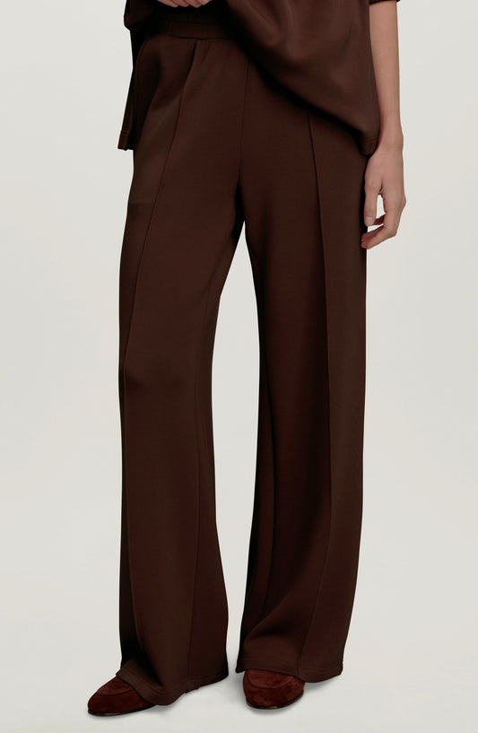 Dark brown wide leg knit pants with raised front seams and elastic waist, worn with a matching top