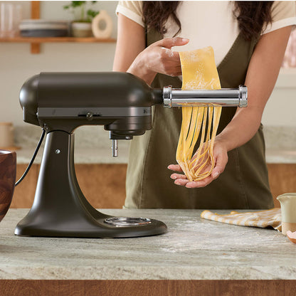 Tilt-Head 5-Quart Stand Mixer  demonstrating pasta attachment- to make pasta in a kitchen setting side view