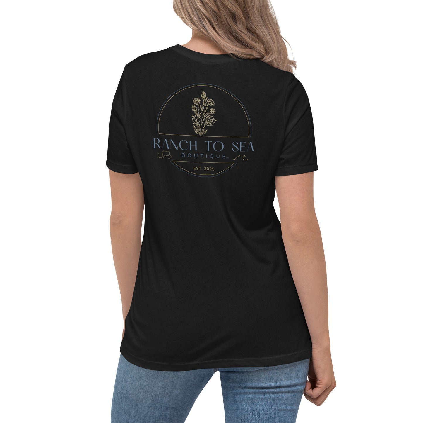 Woman wearing a Black women's relaxed fit tee with Ranch To Sea logo, rear logo view.