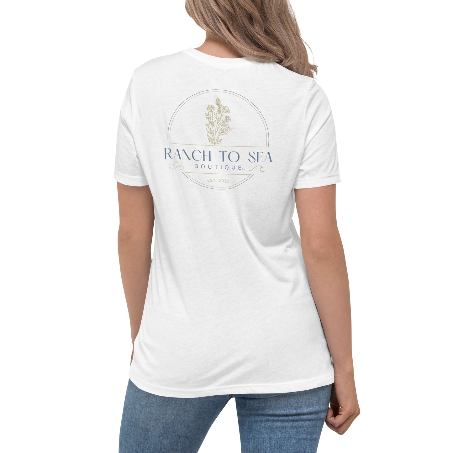 Woman wearing a white women's relaxed fit tee with Ranch To Sea logo, rear logo view.