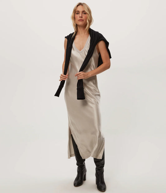 beige satin midi dress layered with a black jacket, on-model front view on white background