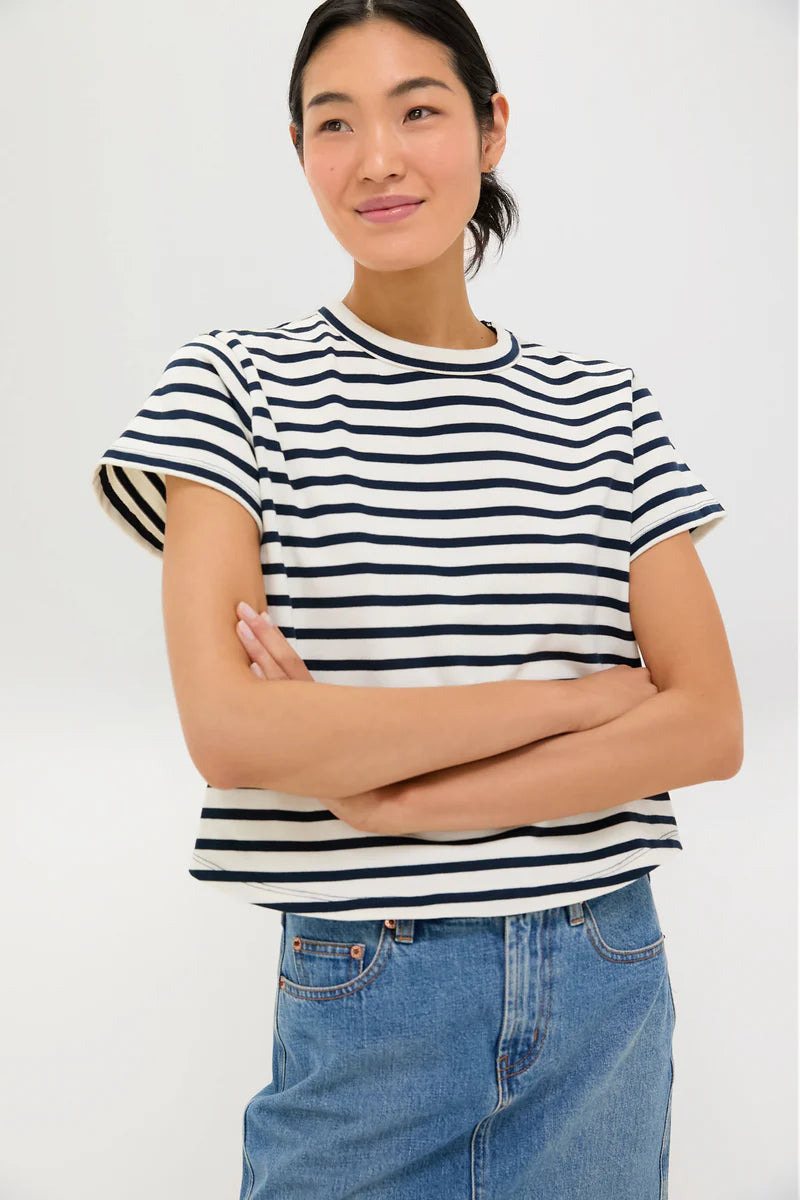 Black & white-Person wearing a black and white striped shirt with blue jeans on a white background
