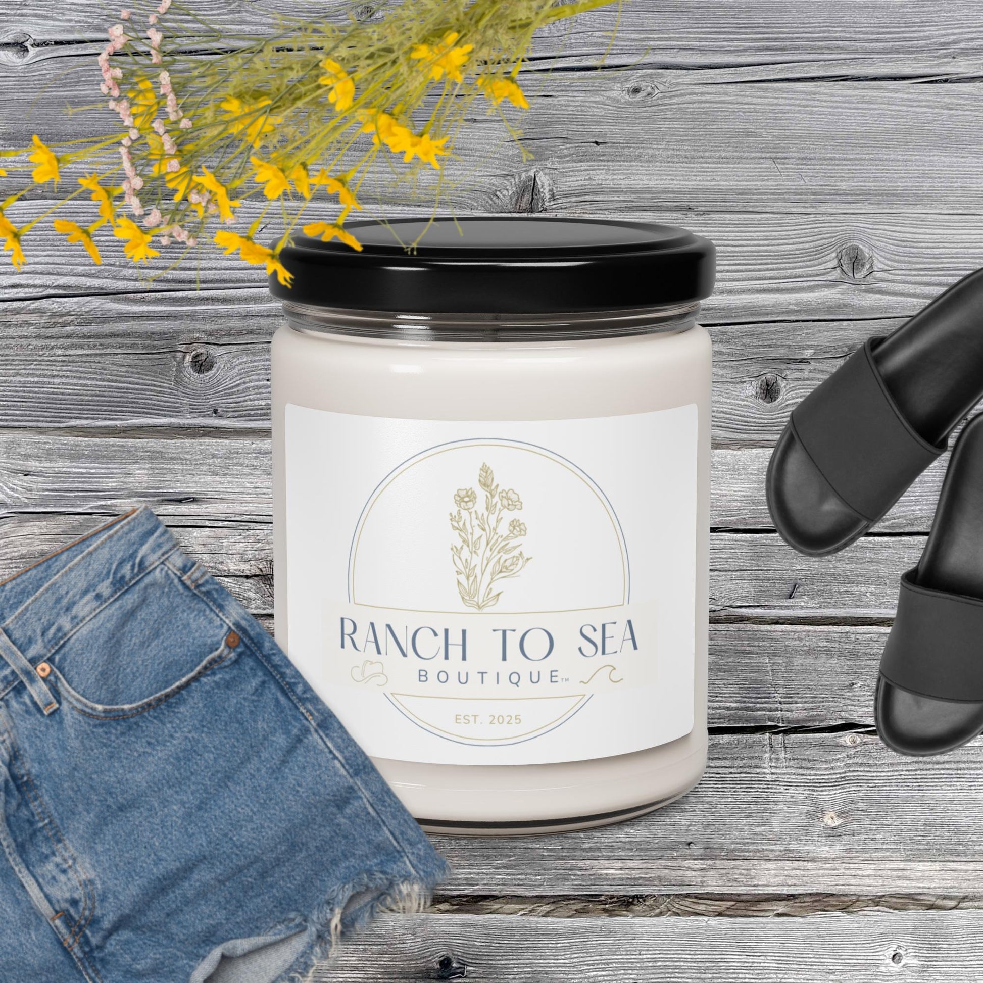 sea salt orchid candle — Ranch To Sea Boutique soy candle with branded label, shown in AI lifestyle concept on wooden surface with denim jeans and sandals (props not included) — results may vary, design image created using AI by RTS, see website for product details