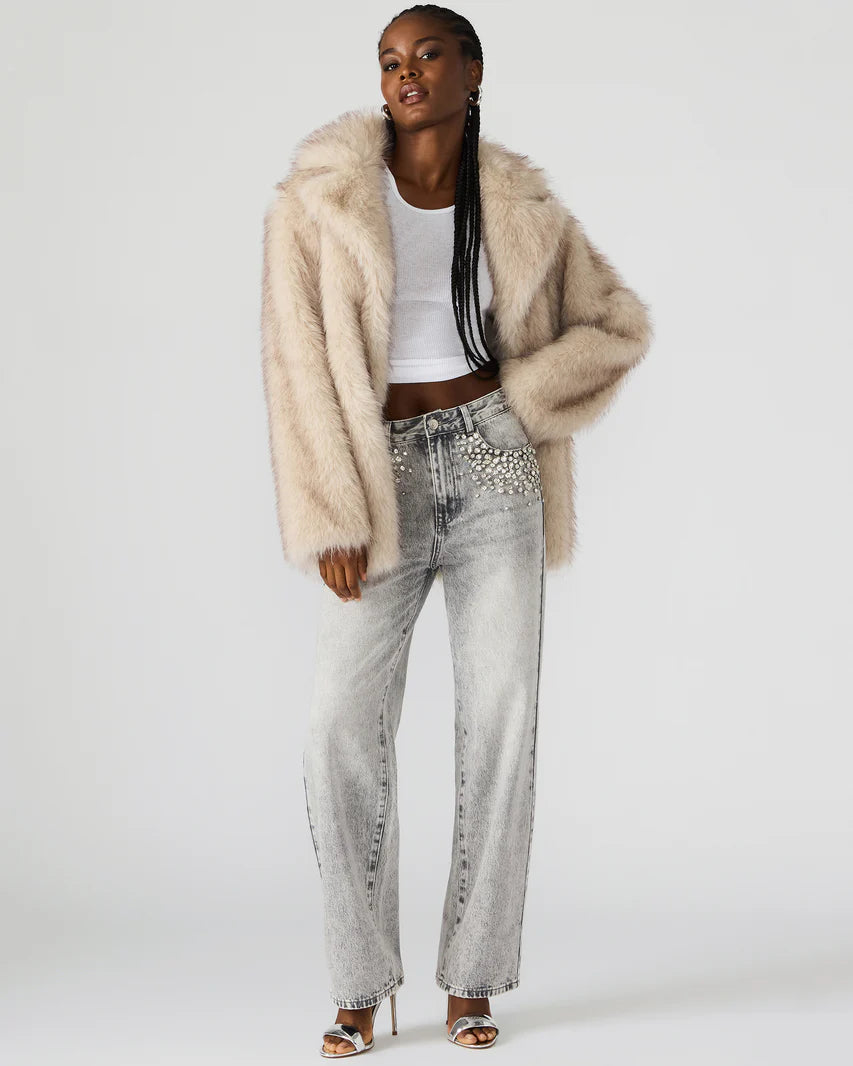 soft cream faux fur — soft cream open-front faux fur jacket with notched lapels, front view, one side tucked behind models arm
